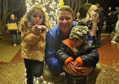 A father with his two children, blowing a kiss to the camera!